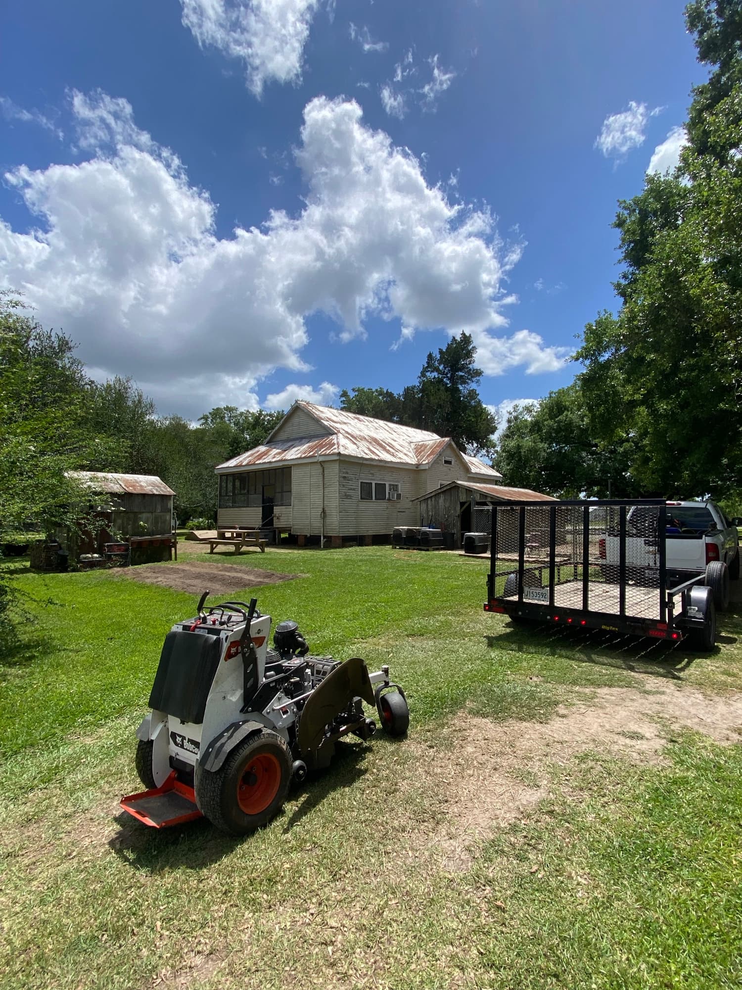 TIMCO Bobcat loader and trailer staged for a commercial job